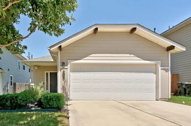 a view of house with backyard