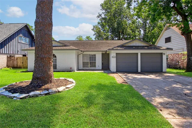 a front view of a house with a garden and yard