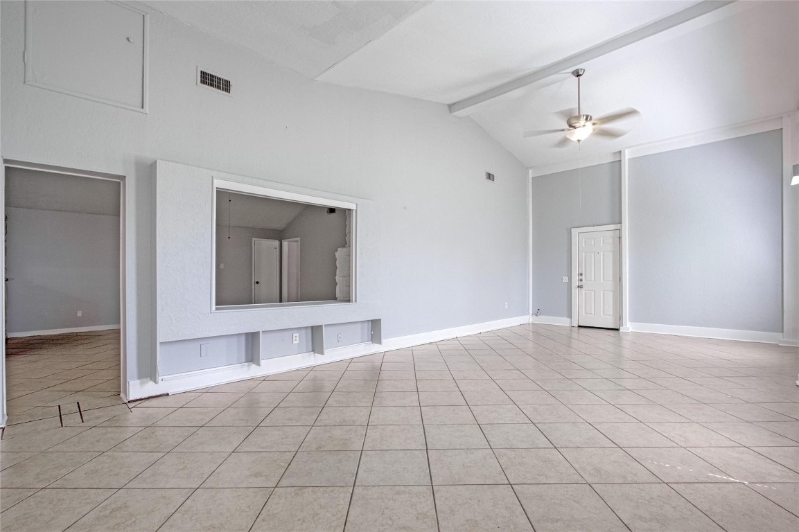 9715 Ballin David Drive Spring, TX 77379 - Photo 12 of 20 a view of an empty room with window and chandelier fan