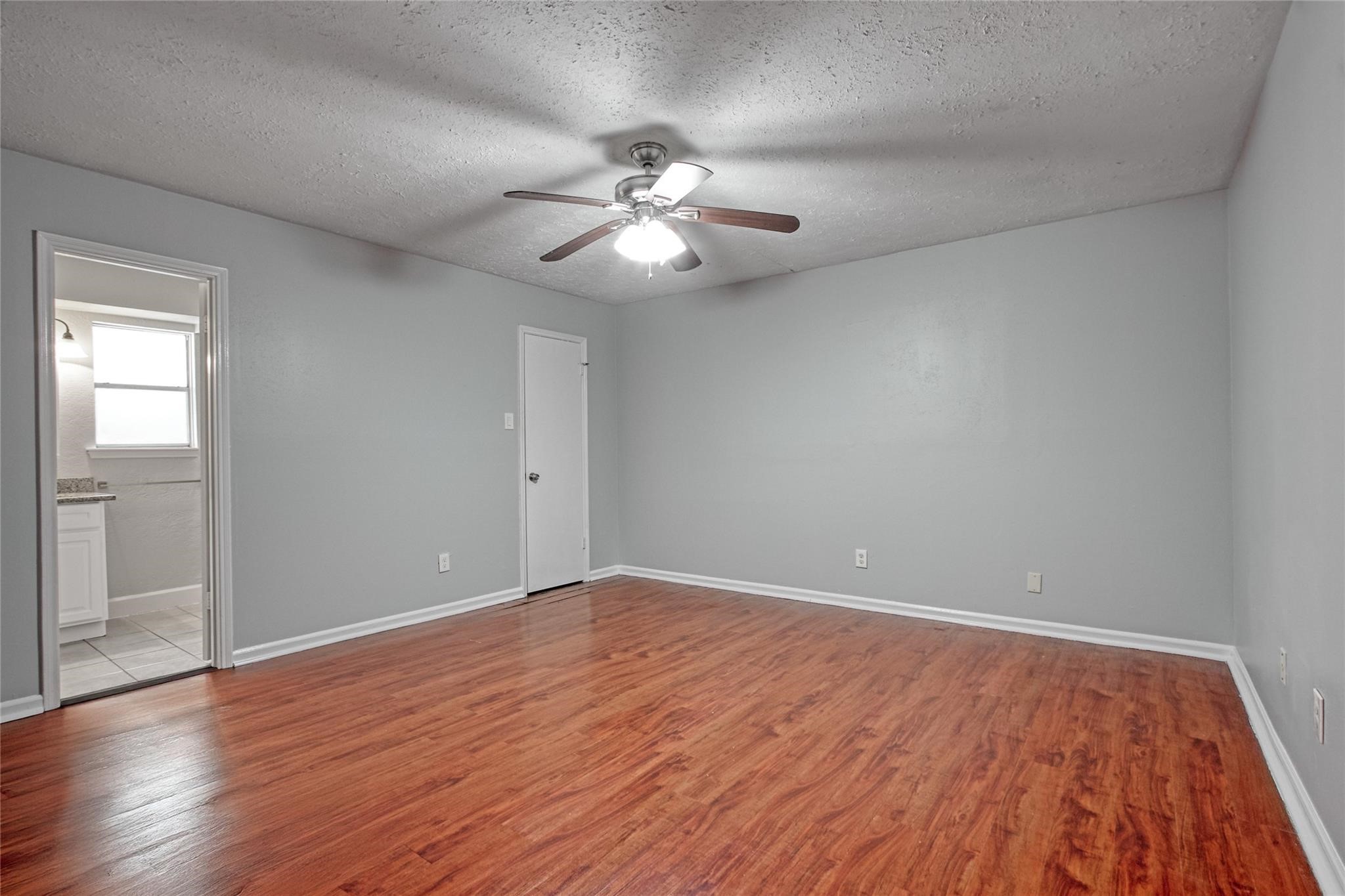 9715 Ballin David Drive Spring, TX 77379 - Photo 13 of 20 a view of an empty room with wooden floor