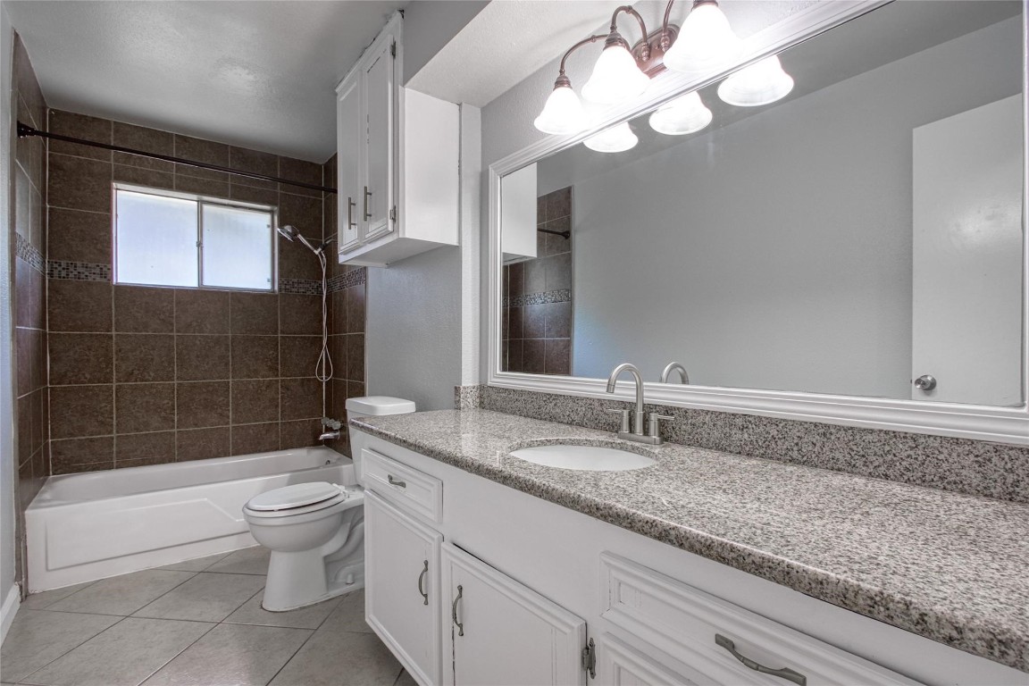 9715 Ballin David Drive Spring, TX 77379 - Photo 14 of 20 a bathroom with a sink a toilet and bathtub