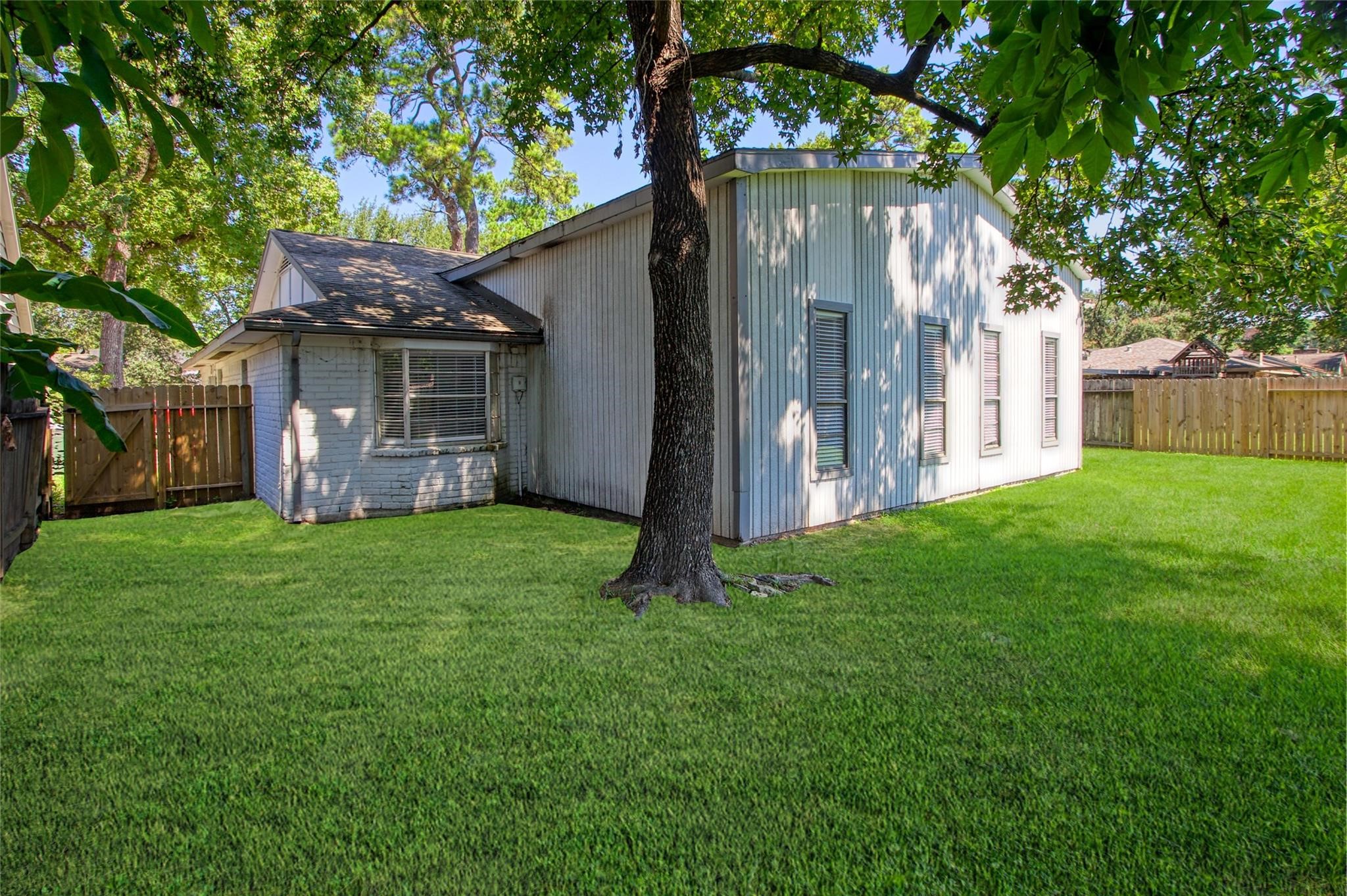 9715 Ballin David Drive Spring, TX 77379 - Photo 19 of 20 a view of a house with a yard
