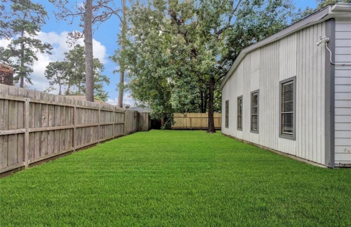 9715 Ballin David Drive Spring, TX 77379 - Photo 20 of 20 a view of a backyard with a garden