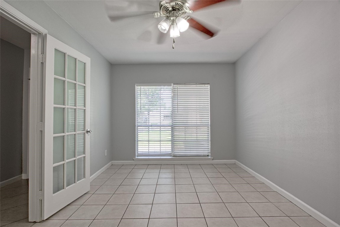 9715 Ballin David Drive Spring, TX 77379 - Photo 3 of 20 a view of an empty room with chandelier fan and fire place