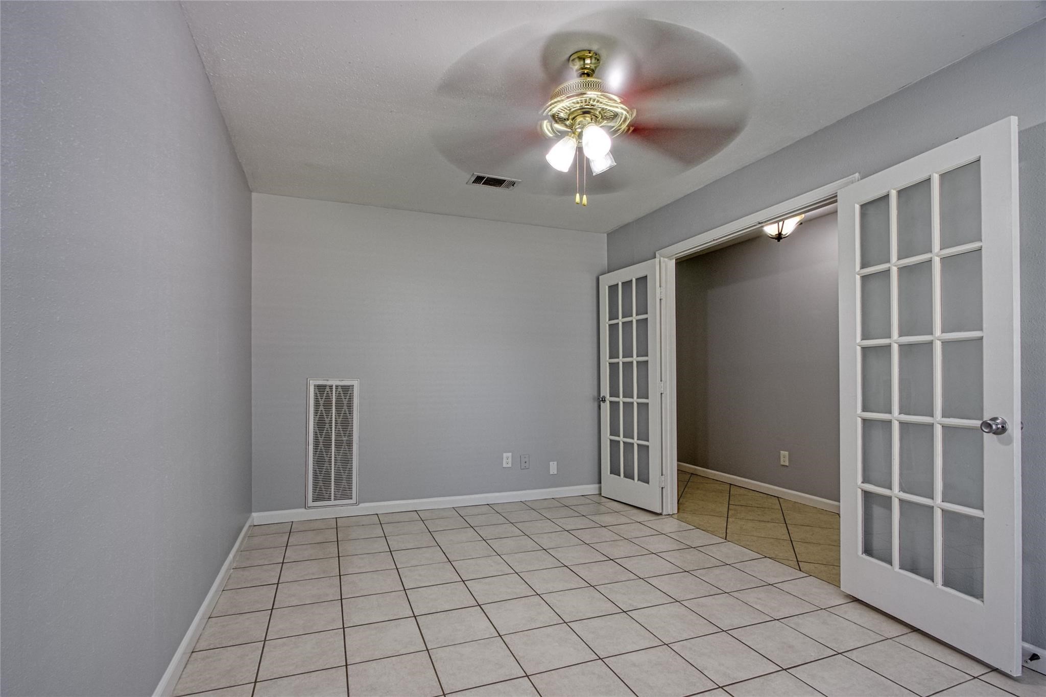 9715 Ballin David Drive Spring, TX 77379 - Photo 4 of 20 an empty room with closet and chandelier fan