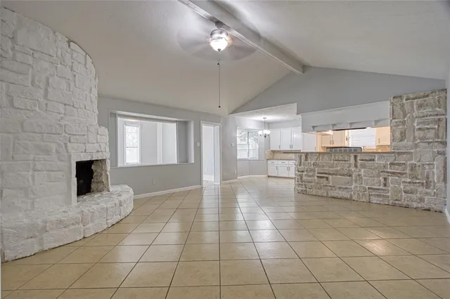 a view of open kitchen with granite countertop a sink and a stove top oven