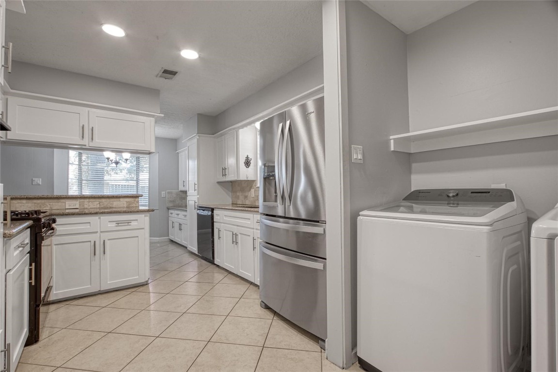 9715 Ballin David Drive Spring, TX 77379 - Photo 8 of 20 a kitchen with a refrigerator sink and stove