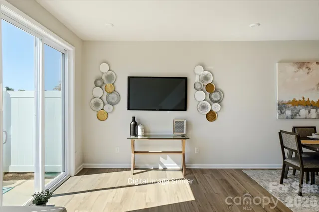 a living room with furniture and a dining table with kitchen view