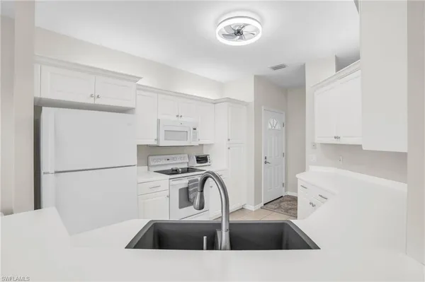 a kitchen with a sink a stove and refrigerator