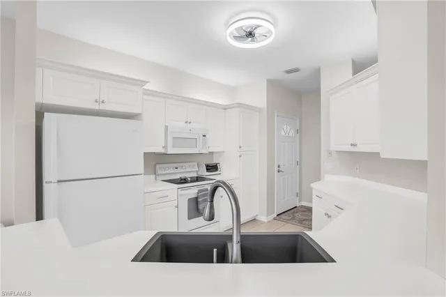 a kitchen with a sink a stove and refrigerator