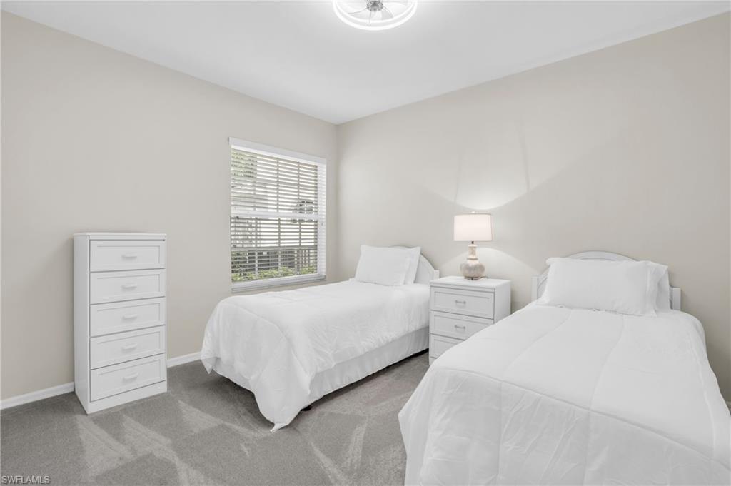 6025 Pinnacle Lane, Unit 602 Naples, FL 34110 - Photo 15 of 43 a bedroom with two beds and a window