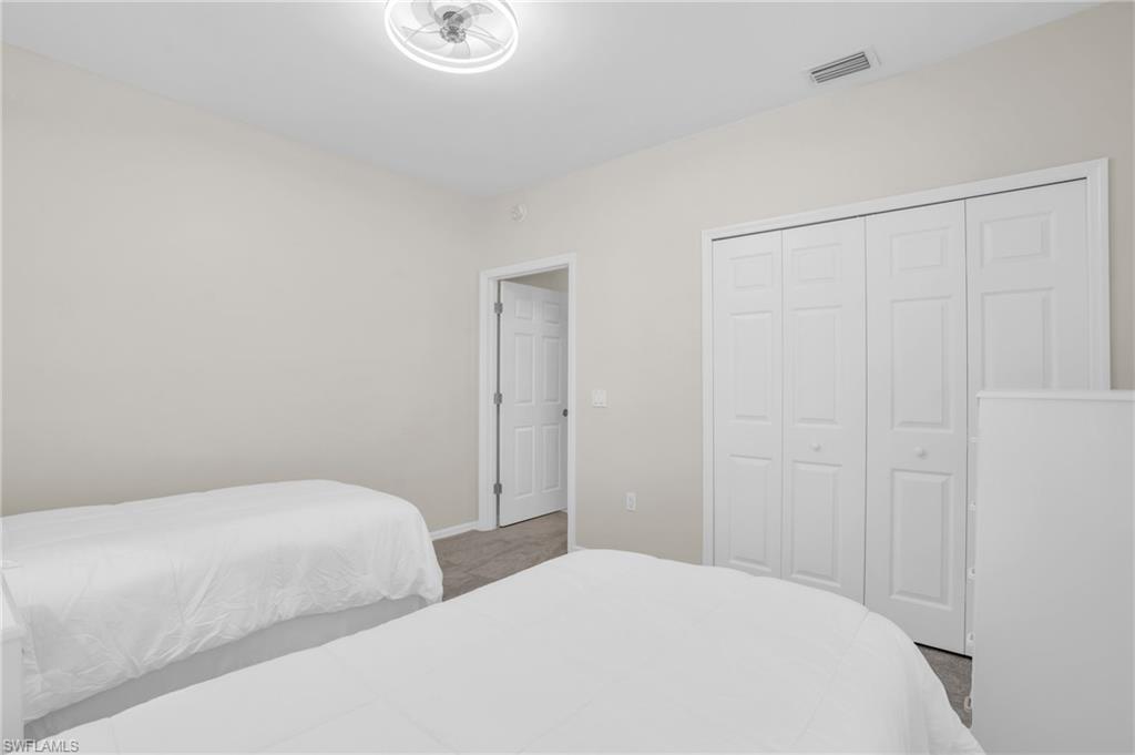 6025 Pinnacle Lane, Unit 602 Naples, FL 34110 - Photo 16 of 43 a bedroom with a bed and a window