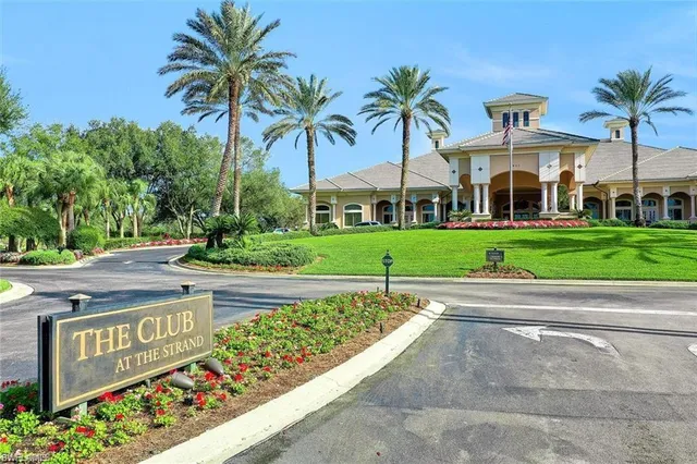 a front view of a house with a yard and palm trees
