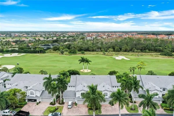 an aerial view of a houses with outdoor space and trees