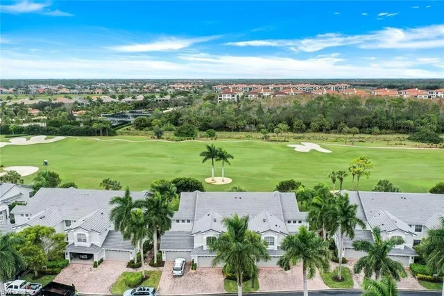 an aerial view of a houses with outdoor space and trees