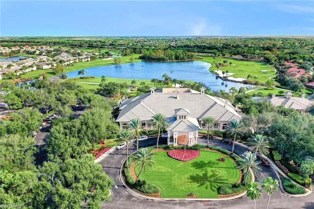an aerial view of a residential houses with outdoor space and lake view