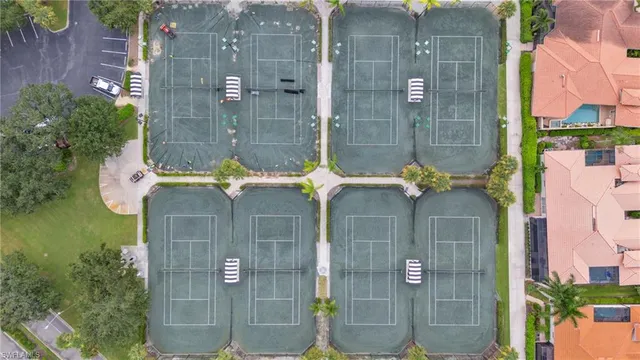 an aerial view of a city with lots of residential buildings ocean and mountain view in back