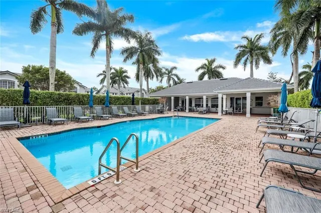 a view of a swimming pool with a table and chairs