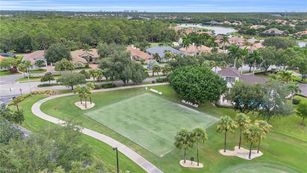 6025 Pinnacle Lane, Unit 602 Naples, FL 34110 - Photo 41 of 43 a view of a lake with a yard