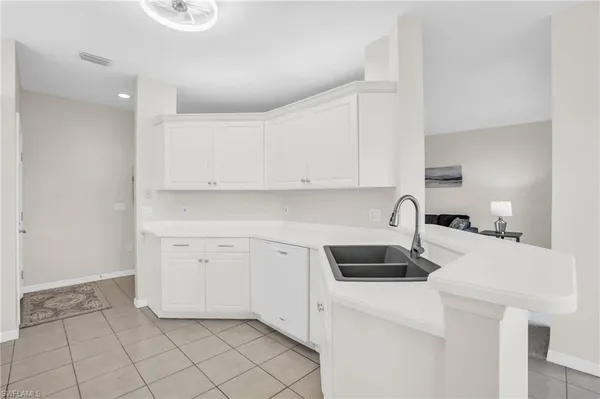 a kitchen with a sink cabinets and appliances