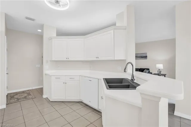 a kitchen with a sink cabinets and appliances