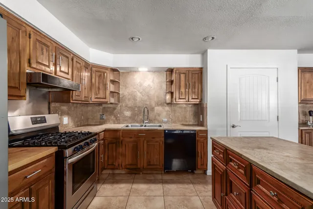 a view of kitchen with stainless steel appliances cabinets and wooden floor