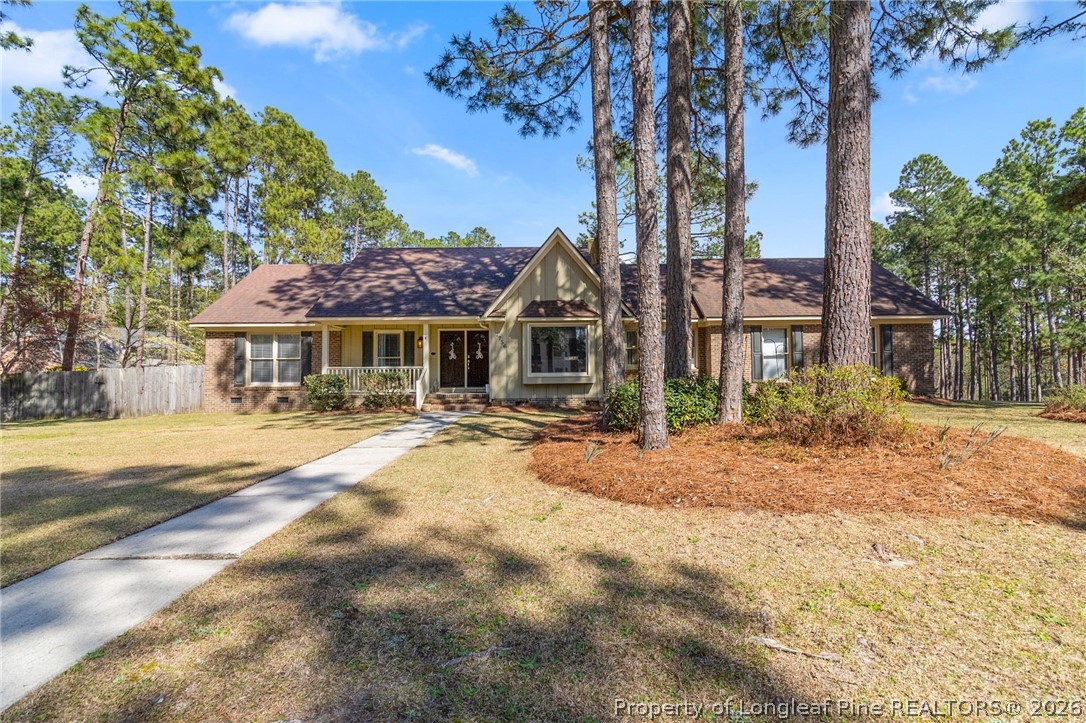 7756 Dragonhead Road Fayetteville, NC 28311 - Photo 2 of 42 a front view of a house with a yard and trees