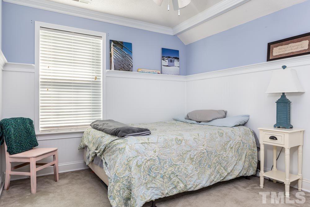 4914 Gable Ridge Drive Durham, NC 27713 - Photo 8 of 23 a bedroom with a bed and a chair with the potted plant
