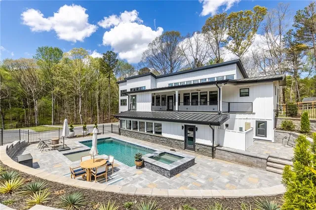 a view of a house with swimming pool and sitting area