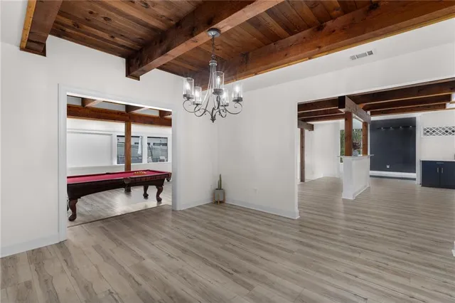 a view of a room with wooden floor