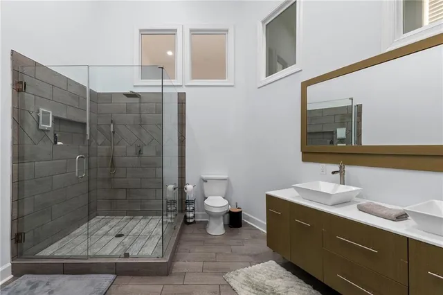 a spacious bathroom with a granite countertop sink and a mirror