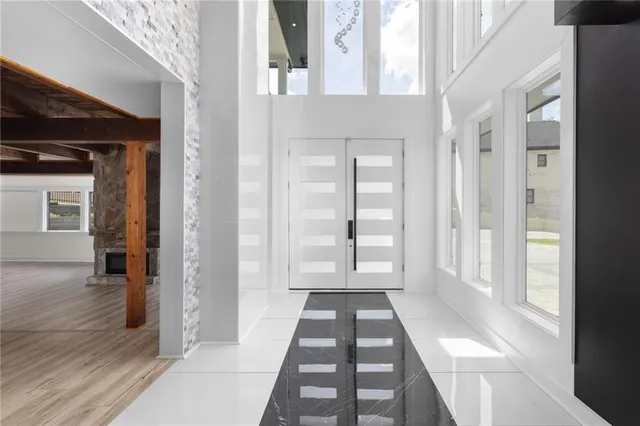 a room with pool table and windows