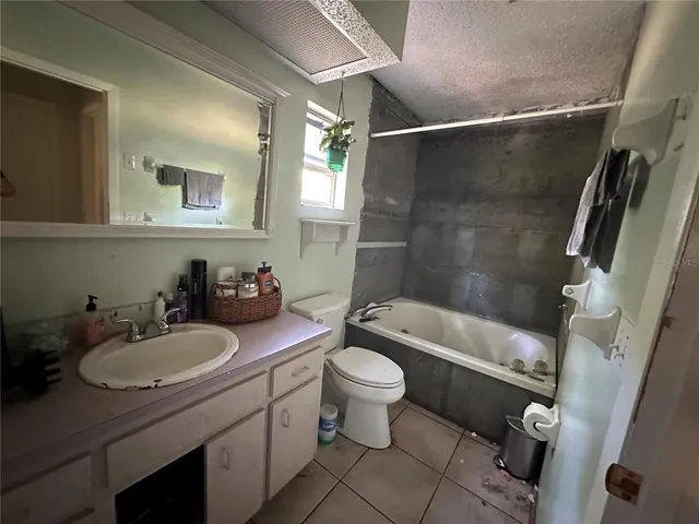 a bathroom with a sink toilet tub and shower