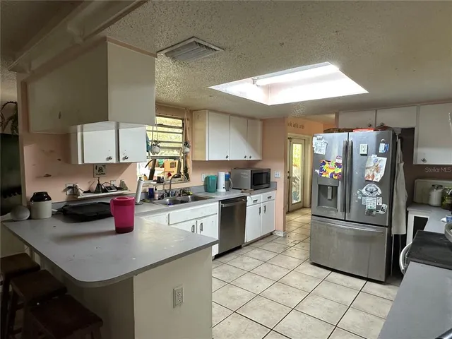 a kitchen with granite countertop stainless steel appliances and sink