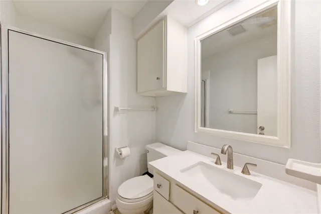 a bathroom with a sink toilet and vanity