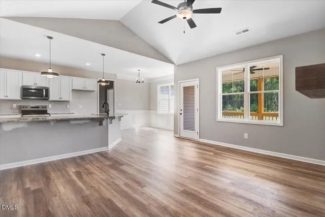 a view of kitchen with stainless steel appliances refrigerator oven and cabinets