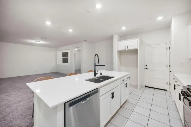 a kitchen with a sink stove and cabinets