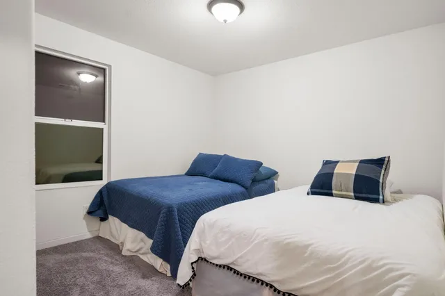 a bedroom with a bed and window