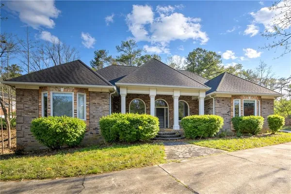 a front view of a house with garden
