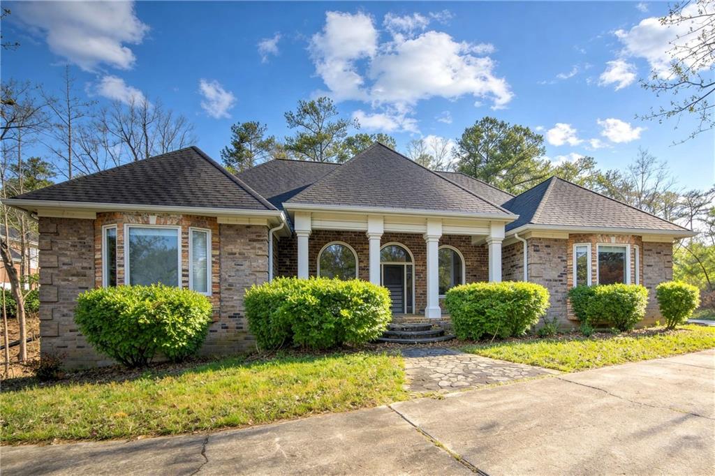 a front view of a house with garden