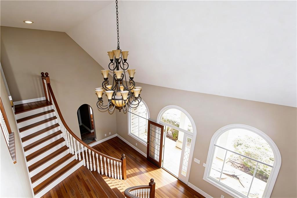 10060 Buice Road Alpharetta, GA 30022 - Photo 14 of 75 a dining room with chandelier and a window