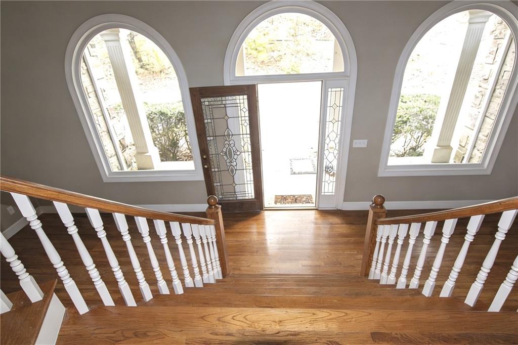 10060 Buice Road Alpharetta, GA 30022 - Photo 16 of 75 a view of empty room with wooden floor and a large window