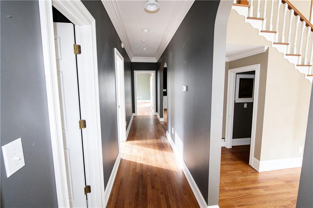10060 Buice Road Alpharetta, GA 30022 - Photo 25 of 75 a view of a hallway with wooden floor and staircase