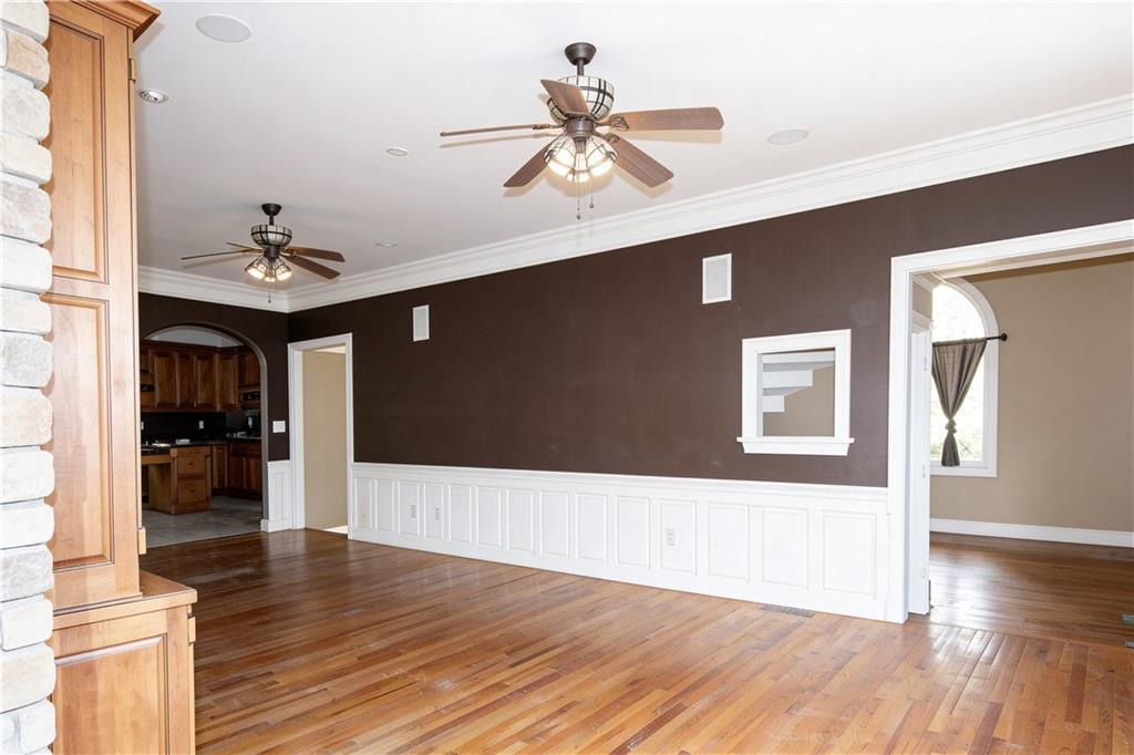 10060 Buice Road Alpharetta, GA 30022 - Photo 27 of 75 a living room with wooden floor and ceiling fan