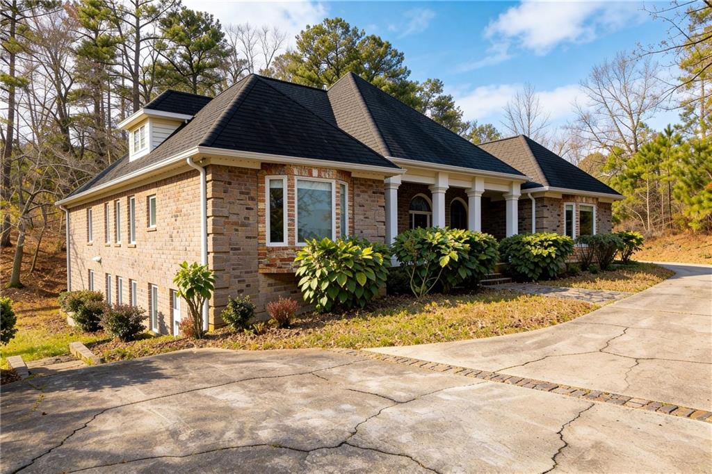 10060 Buice Road Alpharetta, GA 30022 - Photo 3 of 75 a front view of a house with garden