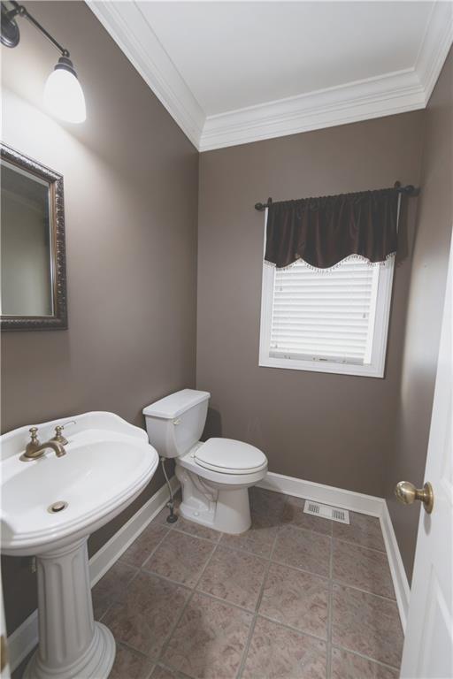 10060 Buice Road Alpharetta, GA 30022 - Photo 31 of 75 a bathroom with a sink toilet and mirror