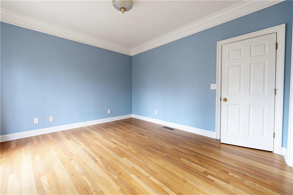 10060 Buice Road Alpharetta, GA 30022 - Photo 35 of 75 a view of an empty room with wooden floor