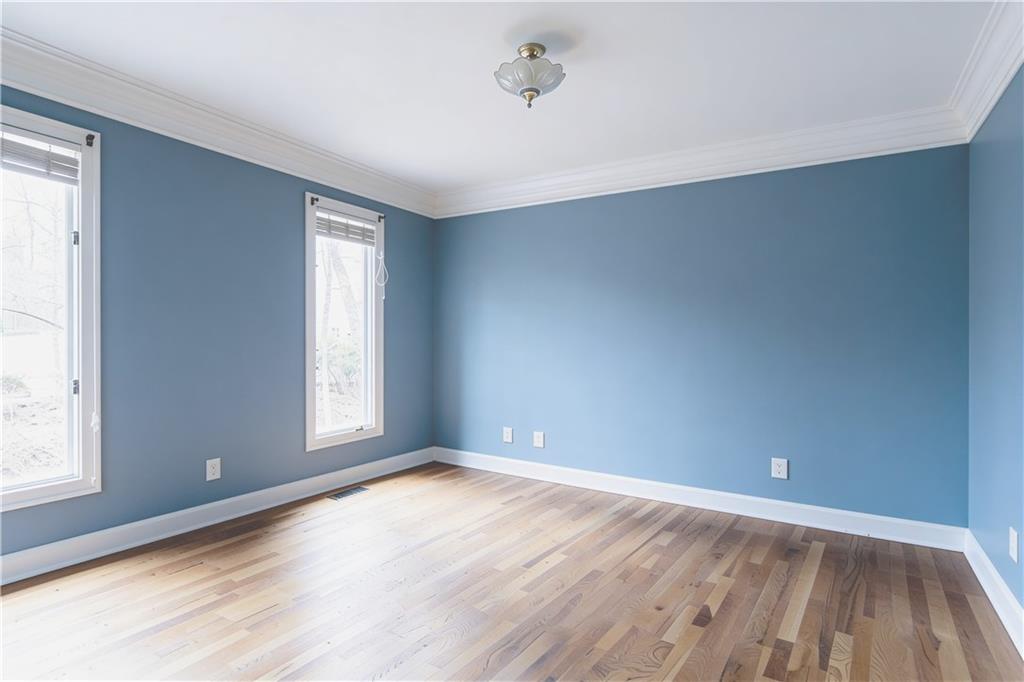10060 Buice Road Alpharetta, GA 30022 - Photo 36 of 75 an empty room with wooden floor and windows