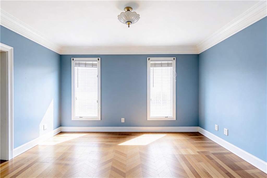 10060 Buice Road Alpharetta, GA 30022 - Photo 37 of 75 an empty room with wooden floor and windows
