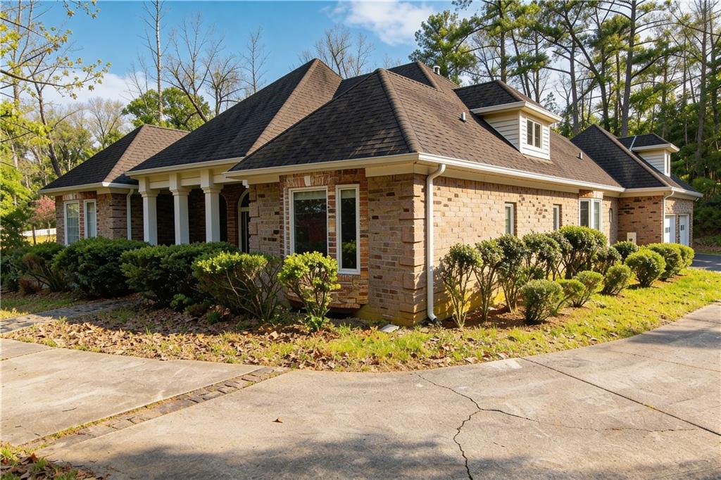 10060 Buice Road Alpharetta, GA 30022 - Photo 4 of 75 a front view of a house with a garden